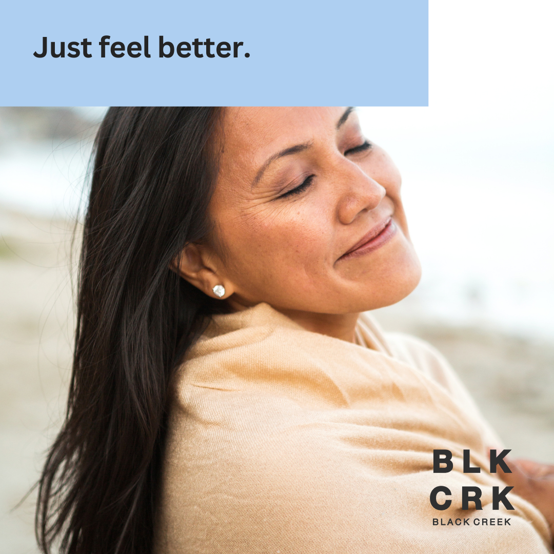 A woman at a beach looking incredibly serene. The text "Just feel better" is at the top. The logo for Black Creek CBD is at the bottom