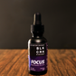 Black Creek CBD's Focus Tincture on a wood surface, black background. Purple and black CBD Tincture for Focus