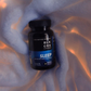 A picture of the Black Creek CBD Sleep Capsules lying on a white blanket, illuminated by soft lights underneath