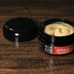 The Black Creek CBD sports cream sitting atop a wooden surface with the lid off to the side. 